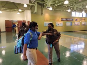 aad first day elbow bump abdullah 300x225